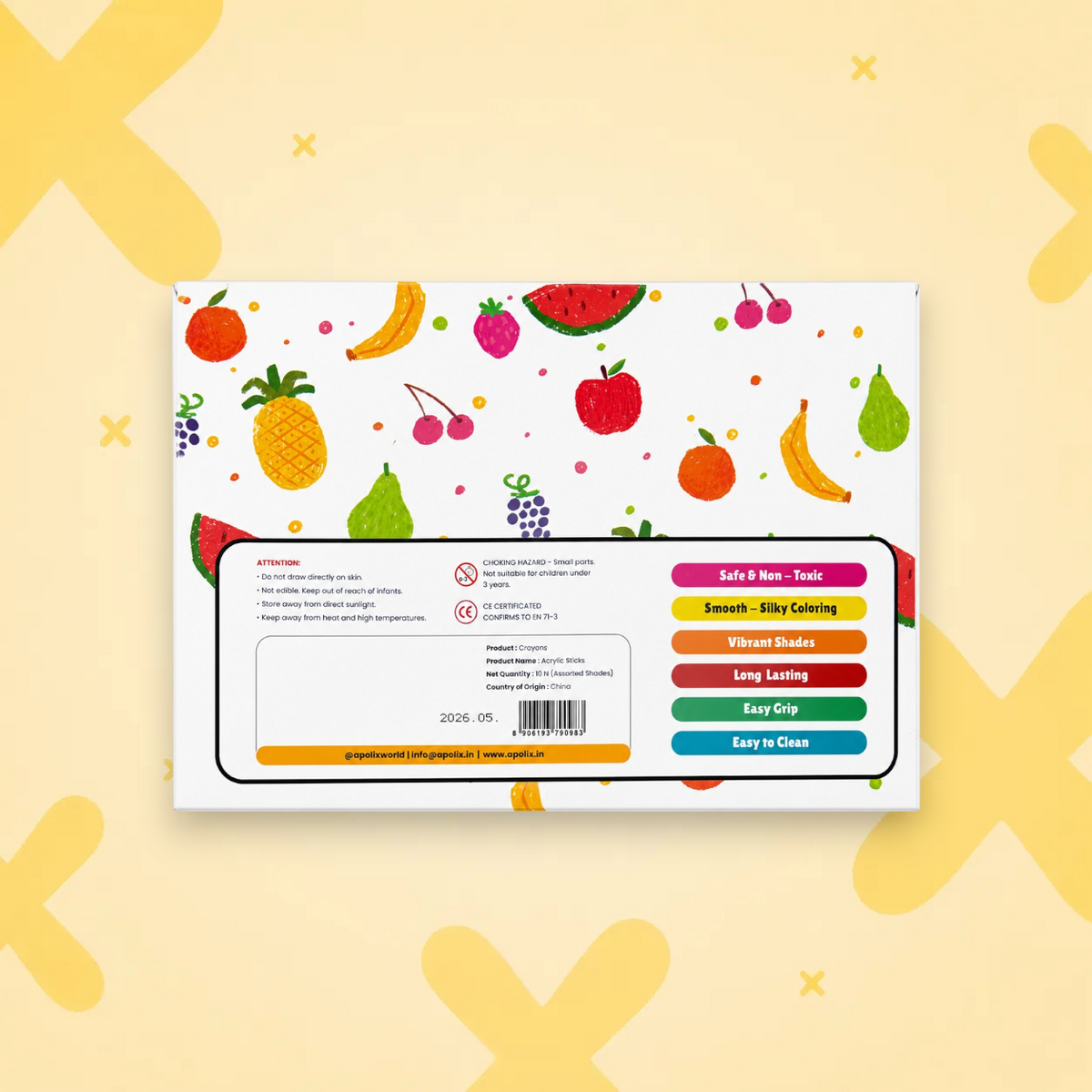 A boxed product shown from the back, featuring a white box decorated with colorful fruit illustrations and a large product information panel with text, barcode, and feature callouts on a pale yellow background with abstract yellow cross shapes.